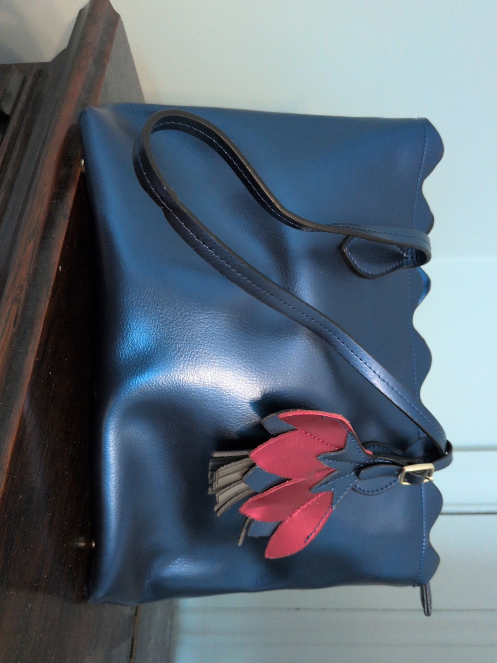 Women’s Navy Shoulder Bag with Red Tassel Accent